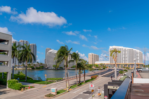 MIAMI, FLORIDA - CIRCA MAY, 2022: Hotels and buildings at Brickell Key island. Bridge to the man-made exclusive island Brickell Key overlooking the river and blue sky on a sunny day.