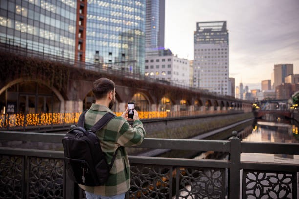 istock Tourist taking photos on bridge in city 1464604420