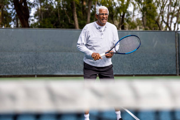istock Handsome senior black man playing tennis 1464605183