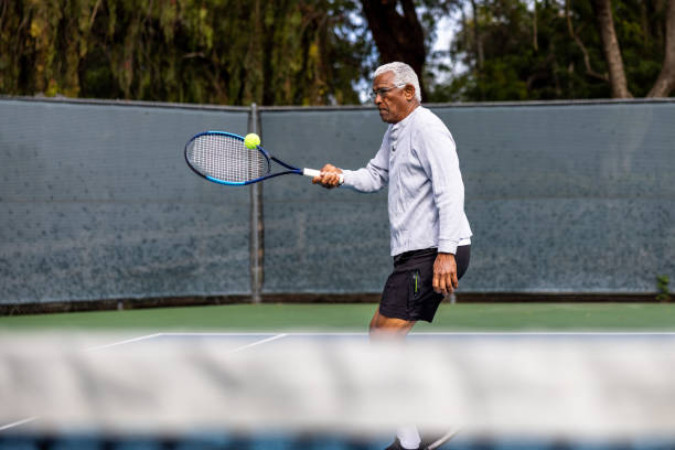 istock Handsome senior black man playing tennis 1464605259