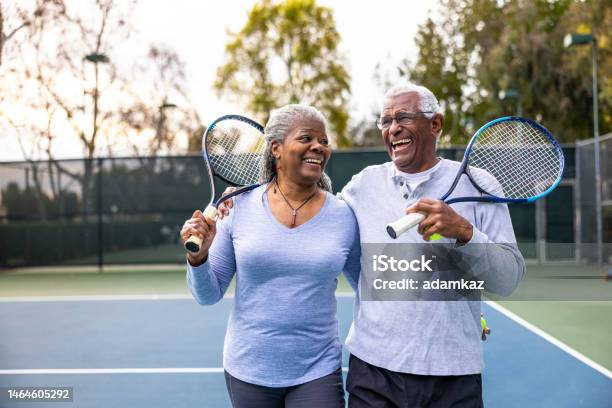 Senior Black Couple Walking Off The Tennis Court Stock Photo - Download Image Now - Exercising, Senior Adult, Retirement