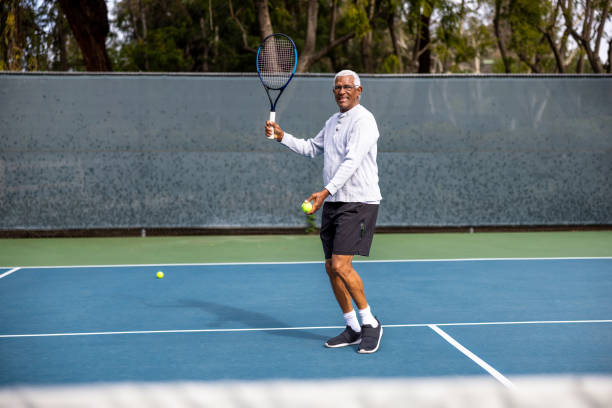 istock Handsome senior black man playing tennis 1464605333