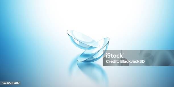 Flying Contact Lenses On The Blue Background Stock Photo - Download Image Now - Contact Lens, Lens - Optical Instrument, Lens - Eye