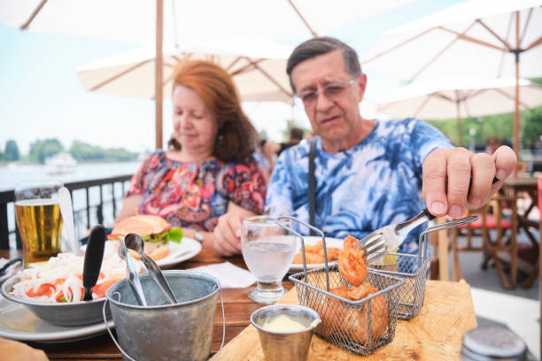 istock Senior hispanic couple having lunch outdoors during summertime. 1464606314