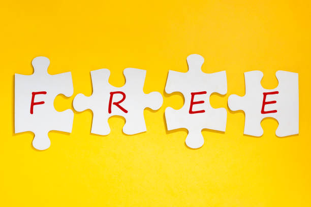 istock word FREE formed with puzzles in row on yellow background 1464607465