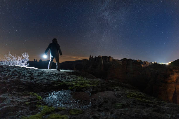 istock Man at night stargazing. Getting away from it all. 1464608300