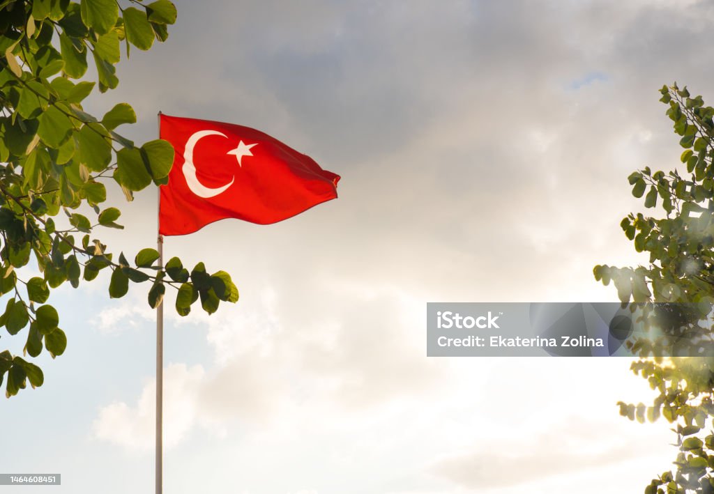 The flag of Turkey is developing in the blue sky. The flag of Turkey is developing in the blue sky Backgrounds Stock Photo