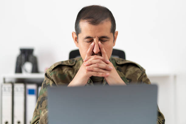 istock male soldier looking stressed out 1464609024