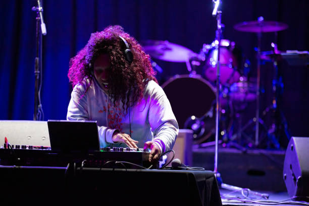 istock Grinning DJ Performing at Music Venue 1464613312