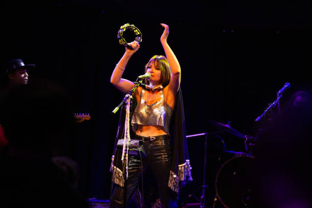 Woman Singing Onstage with Band