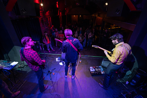 An Americana folk-rock band performing onstage in front of an audience at a live music venue.