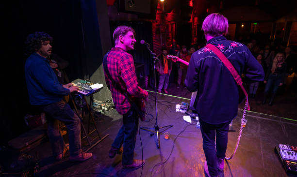 istock Keyboard and Guitar Players Performing Onstage for Audience 1464613364