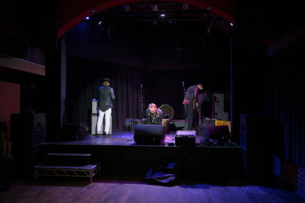 Rock Musicians Setting Up for a Show on Stage in Small Venue
