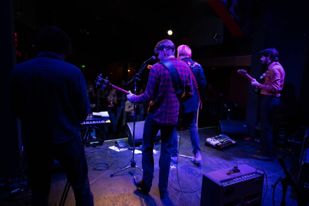 istock Rear View of Musicians Performing Live On Stage 1464613604