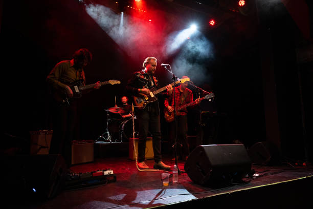istock Rock Band Performing Under Red Stage Lights 1464613616