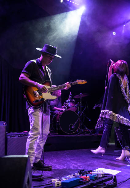 istock Singer, guitarist and Drummer Performing On Stage 1464613631