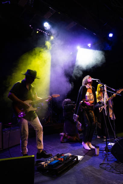 istock Female Fronted Rock Band Performing Live On Stage 1464613648