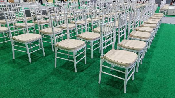 istock White Wooden Chairs arranged in a row for the event 1464619828