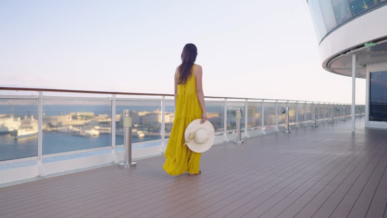 Luxury cruise ship vacation young travel wome enjoying sunset view of luxury cruise ship.