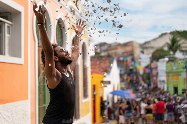 Afro man throwing confetti at Carnival