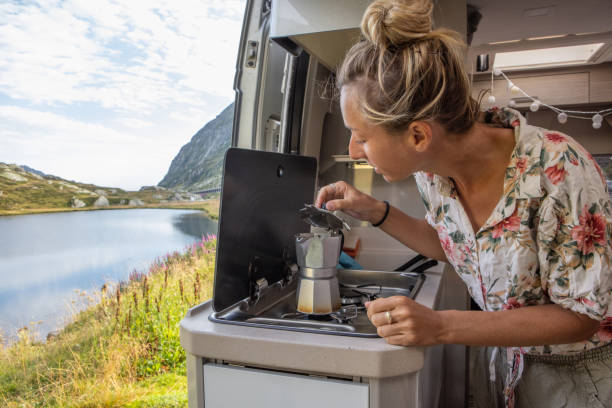 istock Woman making coffee in her camper van. Camping in summer. 1464628659