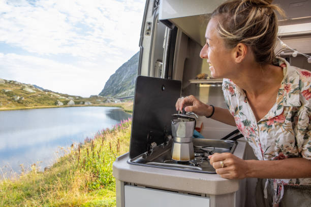 istock Woman making coffee in her camper van. Camping in summer. 1464628662