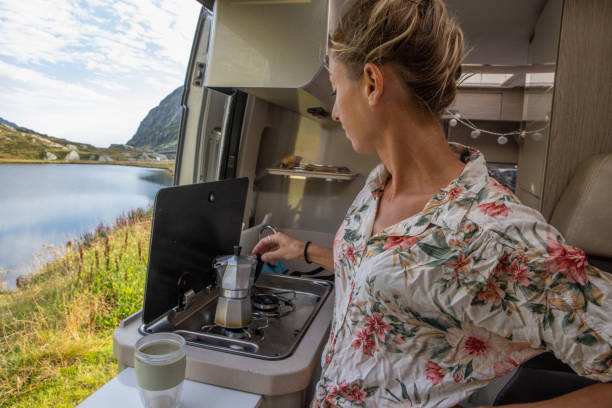 istock Woman making coffee in her camper van. Camping in summer. 1464628702
