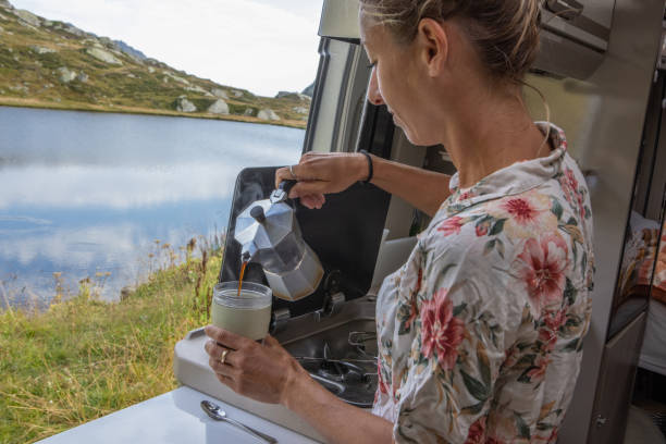 istock Woman making coffee in her camper van. Camping in summer. 1464628719