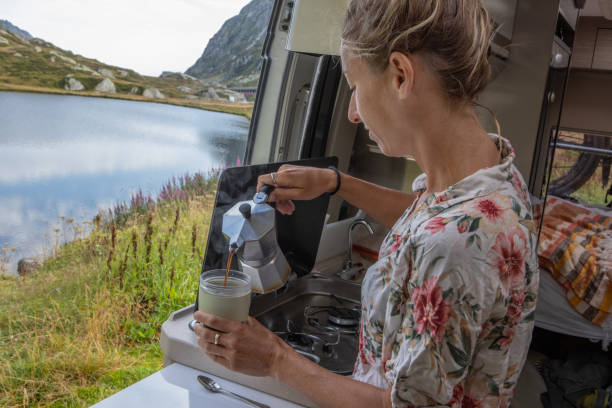 istock Woman making coffee in her camper van. Camping in summer. 1464628779