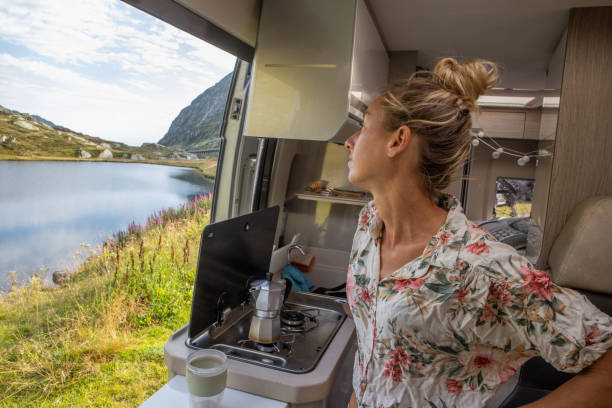 istock Woman making coffee in her camper van. Camping in summer. 1464628811