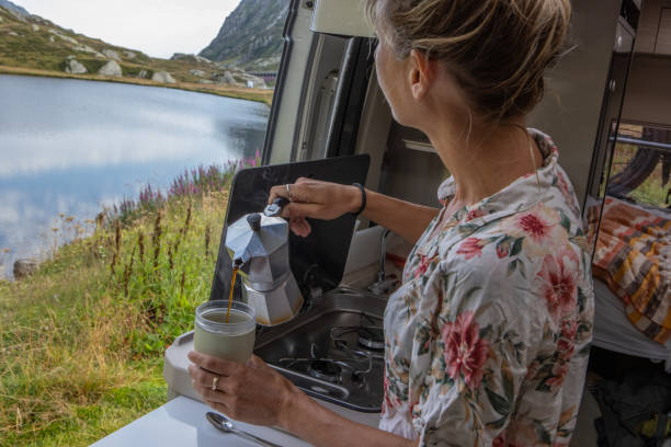 istock Woman making coffee in her camper van. Camping in summer. 1464628823