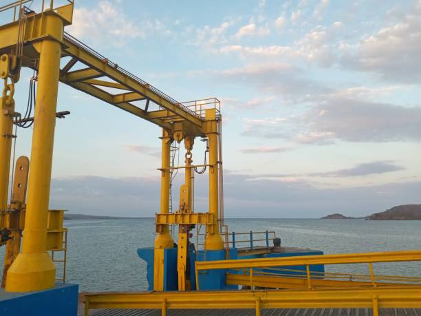 istock Yellow harbor mast with against a blue sea background 1464630733