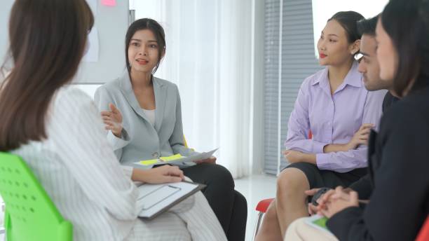 istock Business people proficiently discuss work project while sitting in circle . Corporate business team collaboration concept . 1464631480