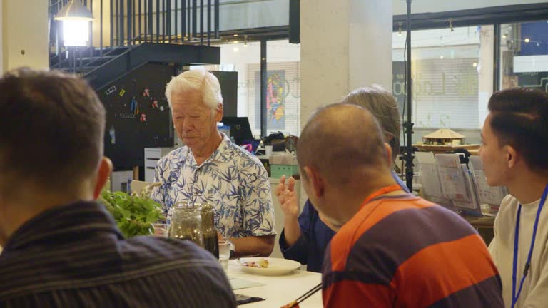 People having lunch in a shared office