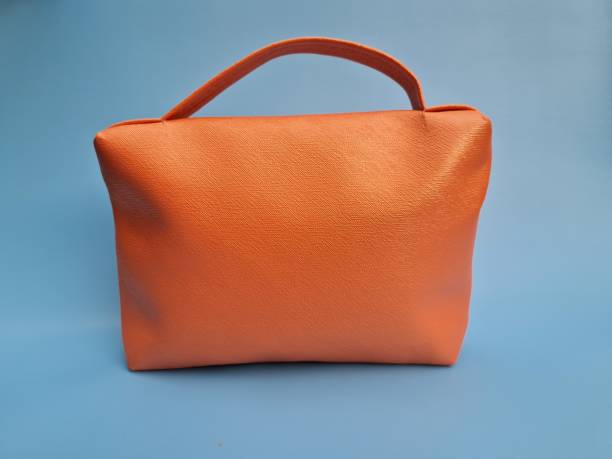 istock Small peach bag made of leather on a blue background 1464631904