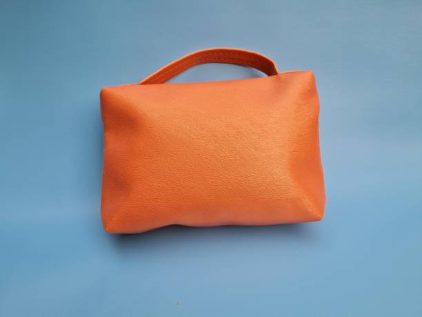 istock Small peach bag made of leather on a blue background 1464631907