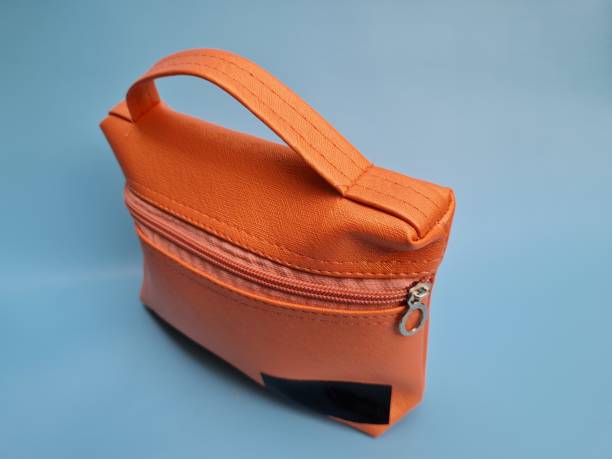 istock Small peach bag made of leather on a blue background 1464631909