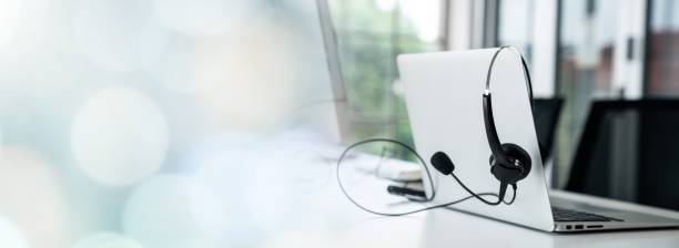 istock Headset and customer support equipment at call center ready for actively service . Corporate business help desk and telephone assistance concept . 1464632712