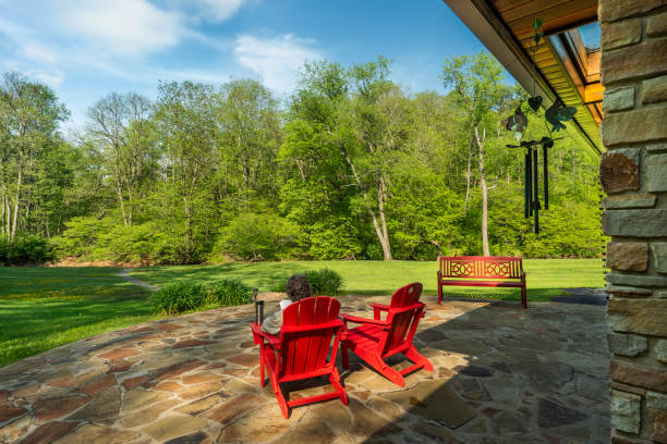 istock Man reading outside in red chair at home 1464636192
