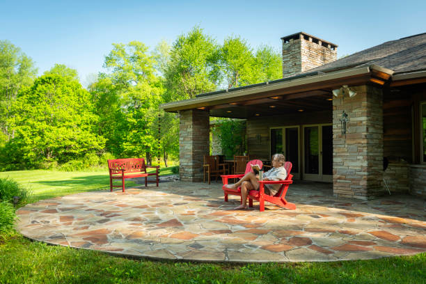 istock Man reading outside in red chair at home 1464636221