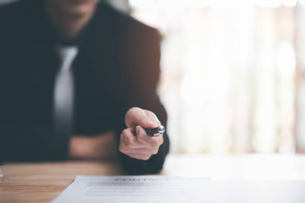 istock Agents Brokers Send pens and contracts to partners, handle business documents and agreements, Business contract signing, business cooperation, commercial signing, Signing an agreement 1464637204
