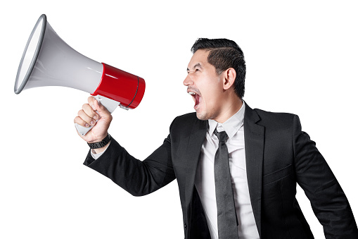 Asian businessman shouting on megaphone isolated over white background