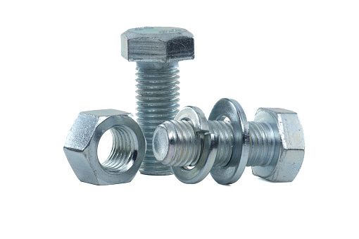 Male screw and hexagon nut, flat nut washer and spring washer coated with a protective layer of zinc isolated on white background