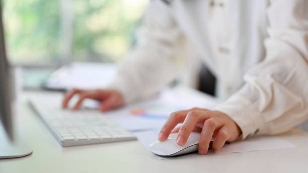 istock A businesswoman using a wireless mouse, working on her business tasks on computer 1464640286