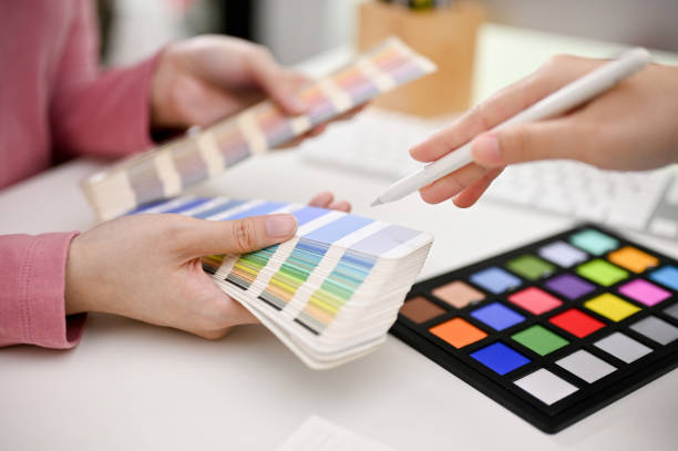 istock Two professional graphic designers discussing and choosing new template for their new website 1464640898