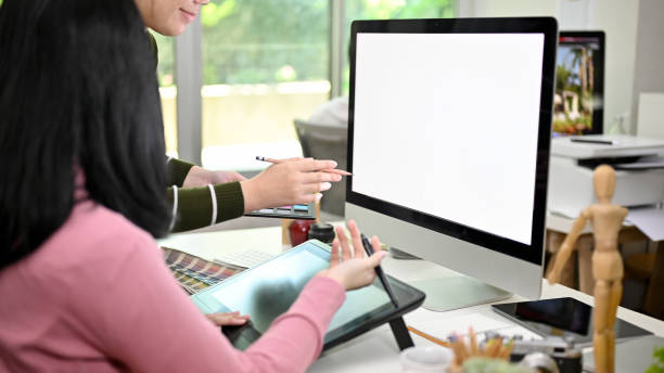 istock Two creative Asian female graphic designers working together in the studio. computer mockup 1464641324