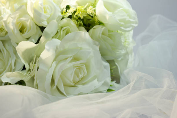 istock Fake white rose bouquet, tulle on table, rose fabric texture, artificial rose bouquet, romatic, valentine, wedding flower. copy space. 1464656448