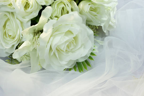istock Fake white rose bouquet, tulle on table, rose fabric texture, artificial rose bouquet, romatic, valentine, wedding flower. copy space. 1464656470