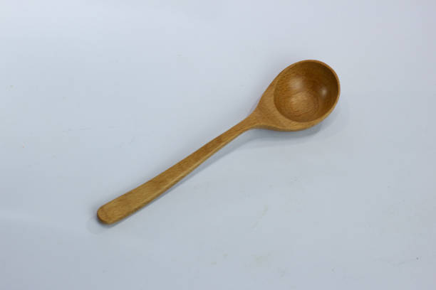 istock selective focus of wooden spoon on white background. 1464657770