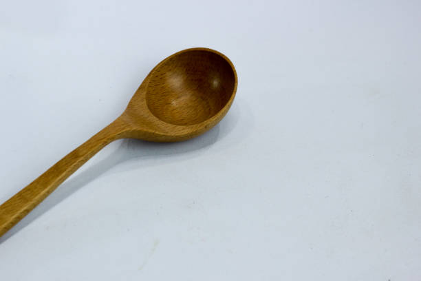 istock selective focus of wooden spoon on white background. 1464657773